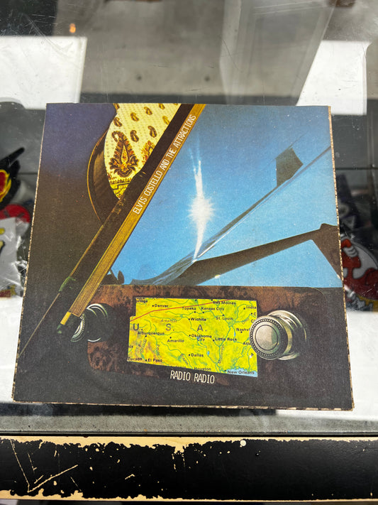 Elvis Costello And The Attractions* ‎– Radio Radio 7”